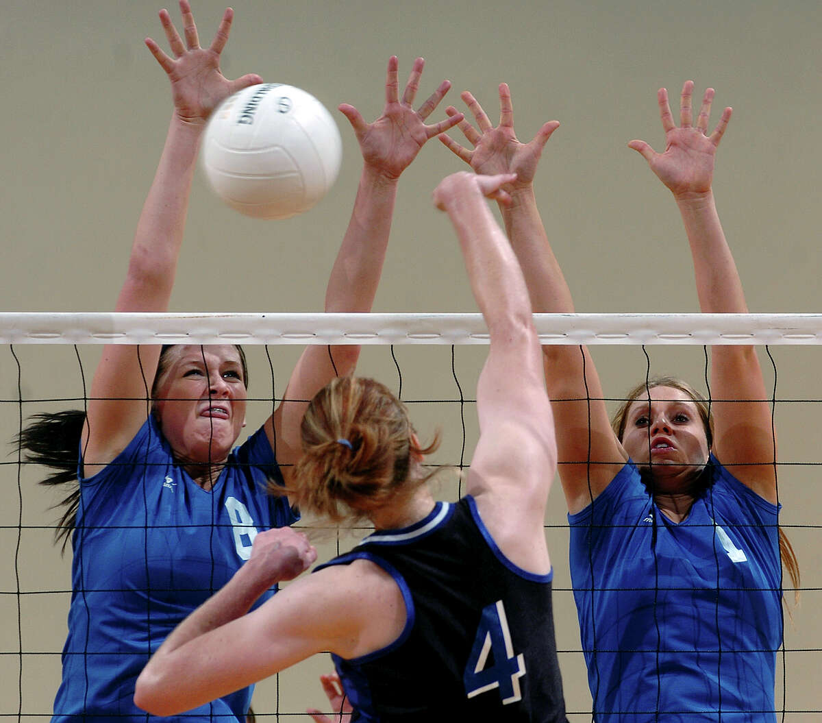 New Braunfels players Amy Huddleston and Taylor Jonas (1) stuff a shot by Lewisville Hebron’s Susie Lesher in San Marcos on Nov. 19, 2005.