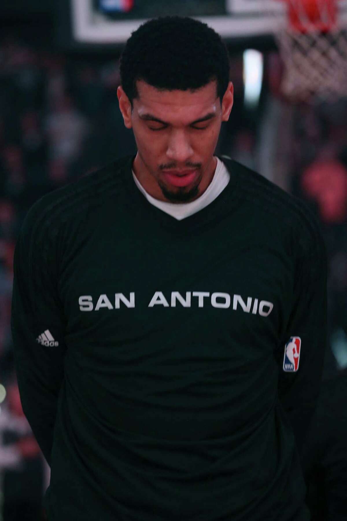 San Antonio Spurs' Danny Green bows his head during the National Anthem before their game against the Denver Nuggets at the AT&T Center, Wednesday, Nov. 18, 2015.