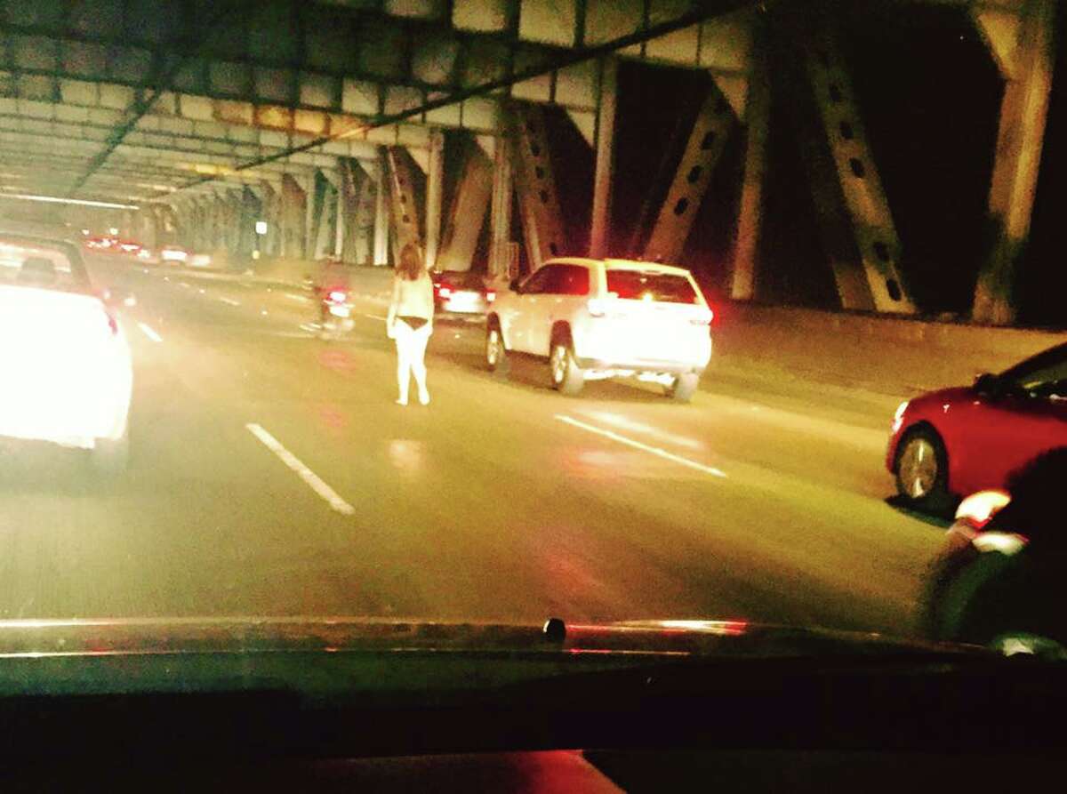 Treasure Island resident Tony Devencenzi captured this image of a partially naked woman walking on the Bay Bridge during the Wednesday evening commute.