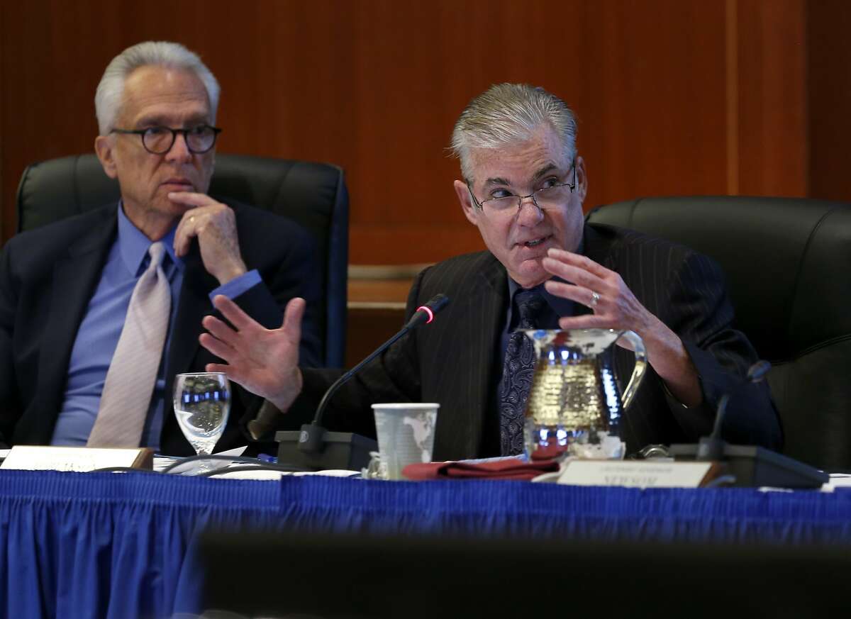 FILE-- Regent Norman Pattiz (left) listens as State Superintendent of Public Instruction Tom Torlakson comments on a proposed three-year financial stability plan during a meeting of the UC Board of Regents at the UCSF Mission Bay campus in San Francisco on Thursday, Nov. 19, 2015.