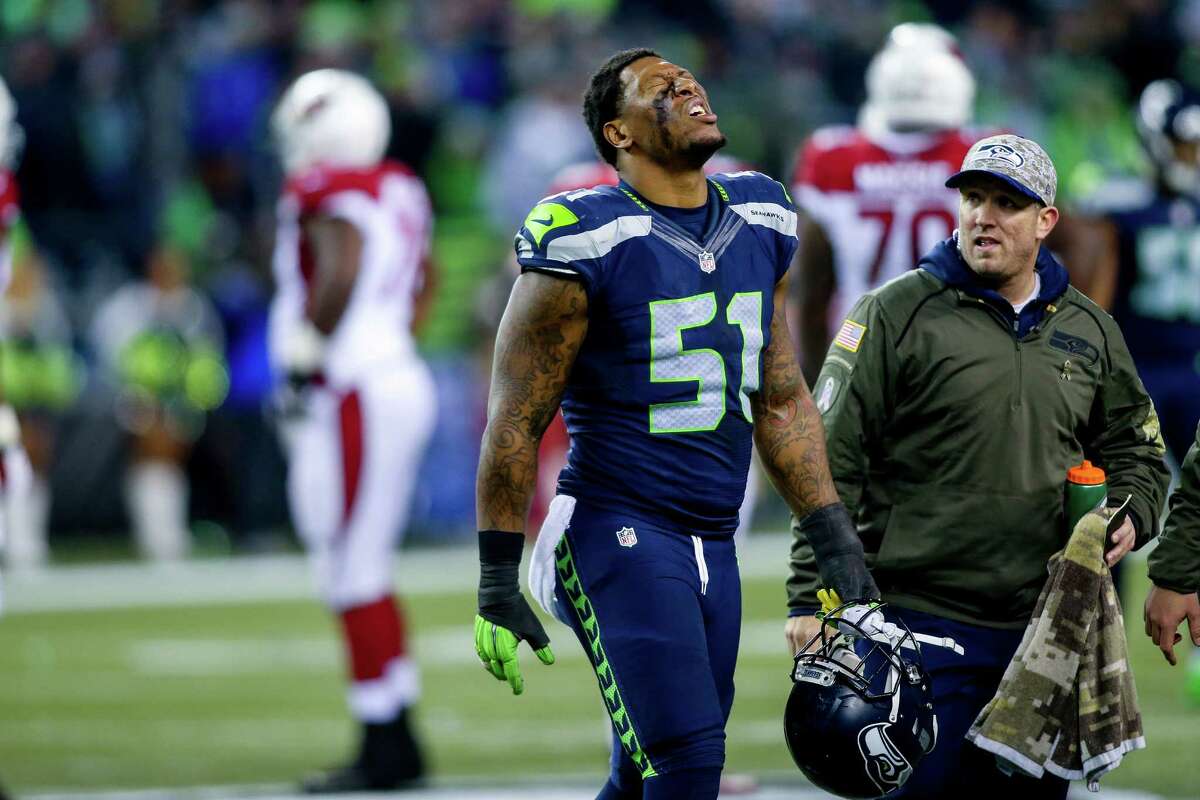 Seattle linebacker Bruce Irvin walks off the field after being injured in the third quarter of the Seattle Seahawks-Arizona Cardinals game, only to return and be knocked out of the game later by injury at CenturyLink Field in Seattle on Sunday November 15, 2015.