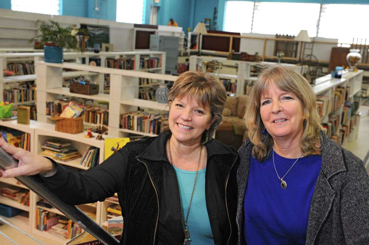 Roberta Sandler, left, and her partner in Grassroots Givers Mary Partridge-Brown stand in front of donated goods at the Grassroots Givers headquarters on Wednesday, Nov. 18, 2015 in Albany, N.Y. The building used to house the Albany YMCA. (Lori Van Buren / Times Union)