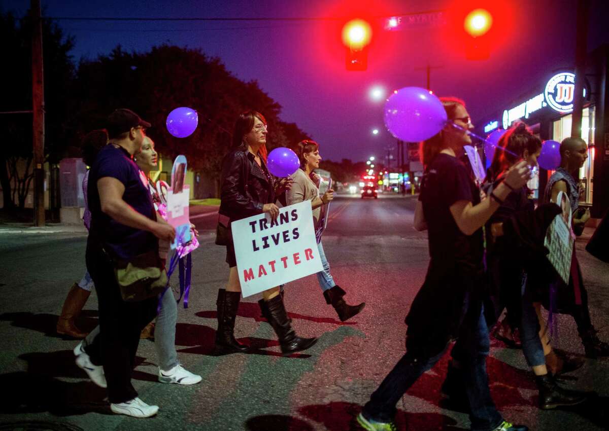 Kelli Maples carries a sign saying "Trans Lives Matter" across the intersection of North Main Avenue and East Myrtle Street during an annual march for Transgender Day of Remembrance in San Antonio, Texas on November 19, 2015. Over thirty people participated in the march, which was lead by the Metropolitan Community Church, to honor those murdered in the U.S. because of anti-transender prejudice. "Nobody should die because of who they are," Maples said.
