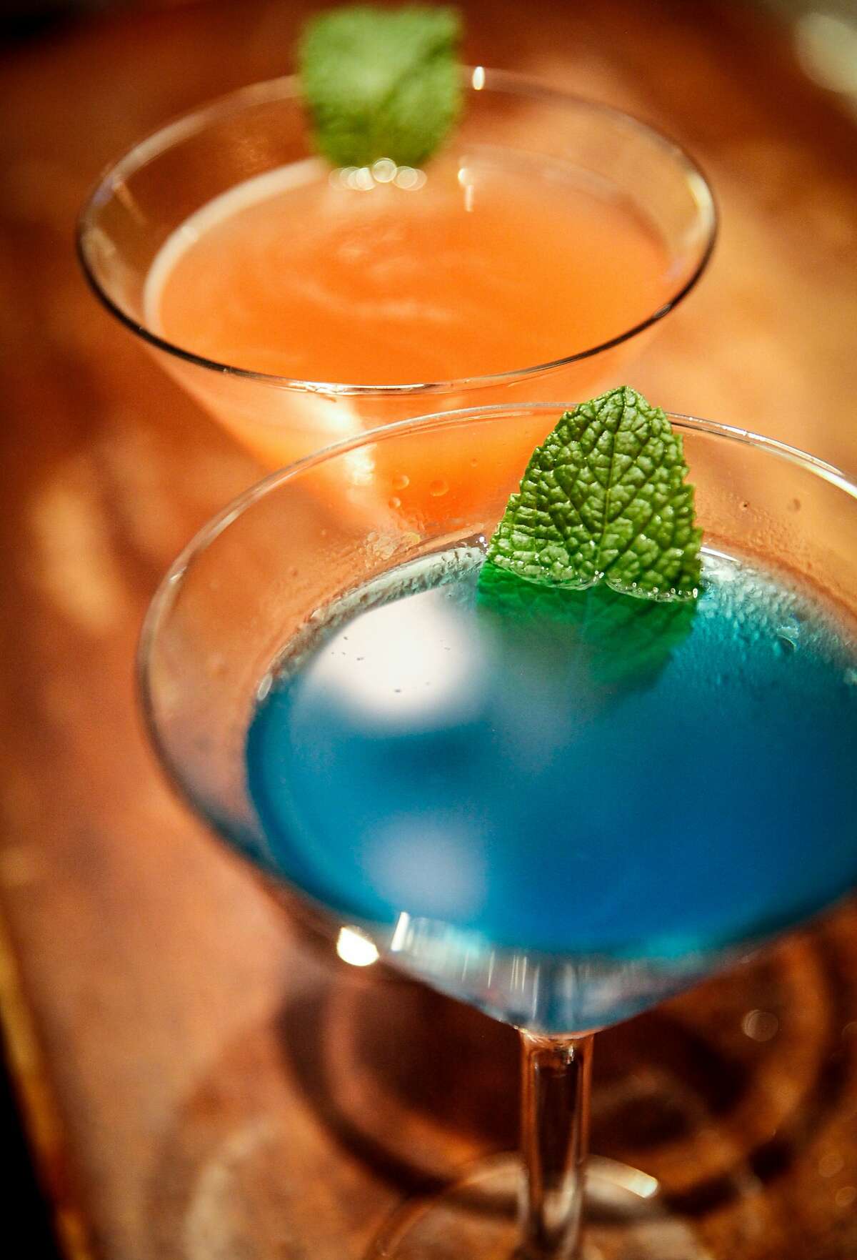 The namesake drinks, a blue and a pink sardine martini, at the Sardine Factory in Monterey, Calif., Saturday, November 14, 2015. The blue sardine martini is gin, hpnotiq liquer, peach schnapps and blue curacao with a splash of fresh lime juice garnished with garden fresh mint. The pink sardine martini is x rated vodka infused with mango, passion fruit and blood orange, and a splash of pineapple in a mint leaf rimmed glass.
