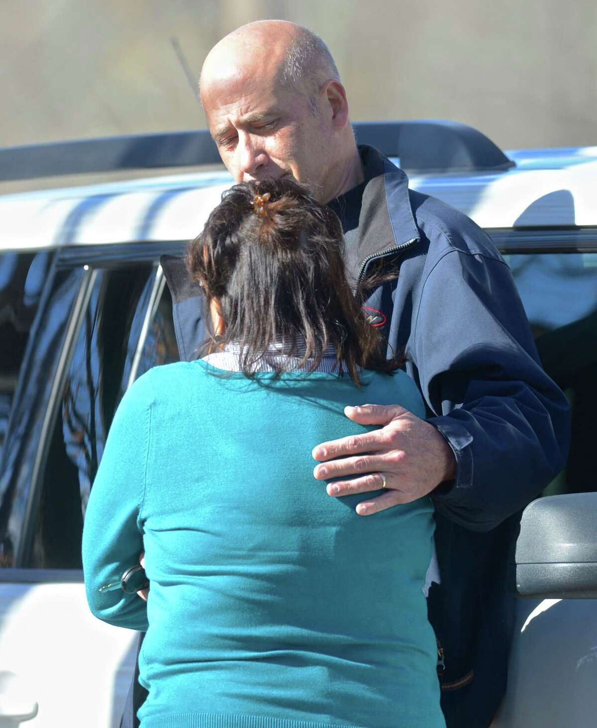 Eric Horsa, of Ridgefield, comforts his wife, Portia, as authorities on Friday search the Titicus Reservoir in North Salem, N.Y., for a small plane that went missing during its approach to Danbury Airport. Horsa said he believes his father, Val Horsa, and his stepmother, Taew Robinson, were on the small plane.