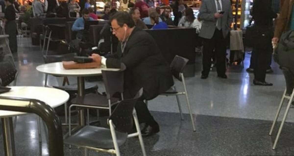 New Jersey Gov. Chris Christie waits at San Francisco International Airport Friday after his United Airlines flight was turned turned back to the gate so police could remove a passenger.