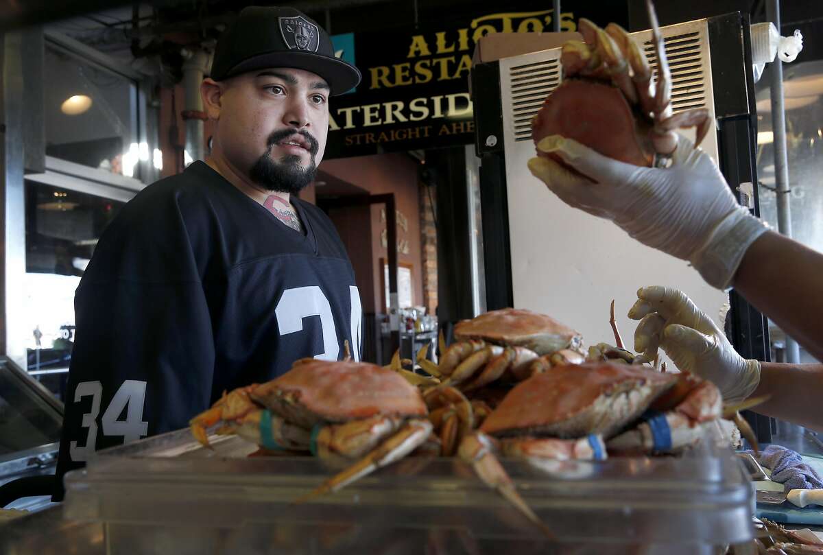 Matthew Stagi selects a Dungeness crab imported from Washington state at Nick's Lighthouse restaurant on Fishermans Wharf in San Francisco, Calif. on Friday, Nov. 20, 2015. Recent tests indicate that domoic acid in Dungeness crab have dropped to acceptable levels but it will still take a little while longer to lift the ban on the local crabbing season.