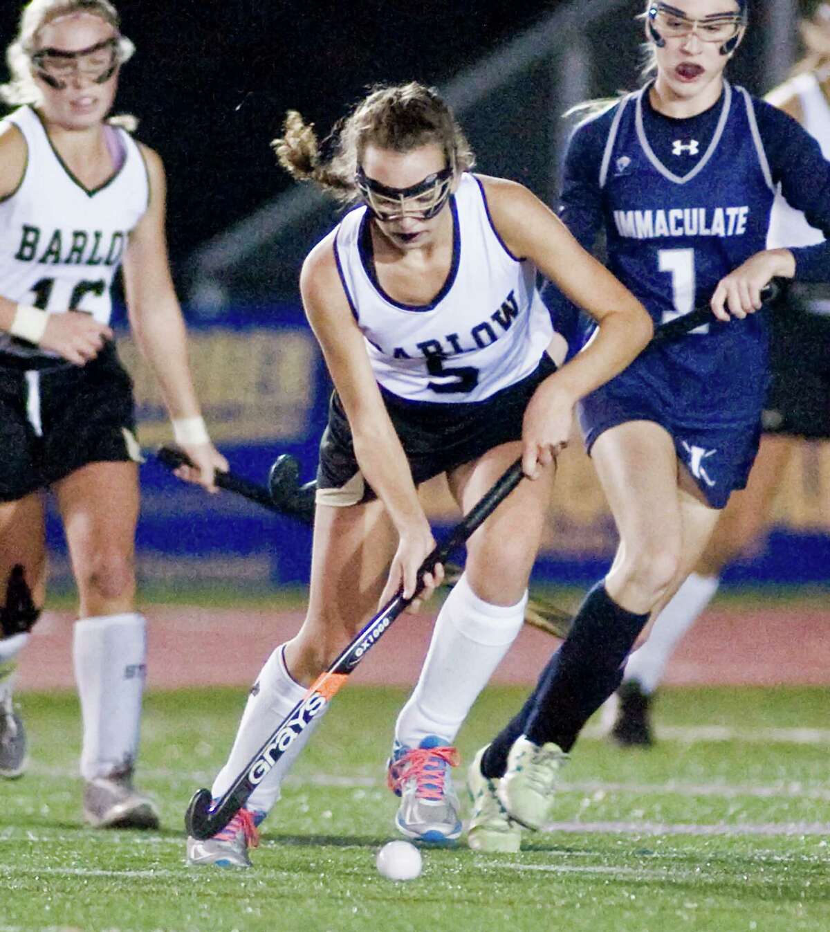 Joel Barlow High School's Gloria Davey pushes the ball in the SWC field hockey championship game against Immaculate High School, played at Brookfield High School. Wednesday, Nov. 4, 2015