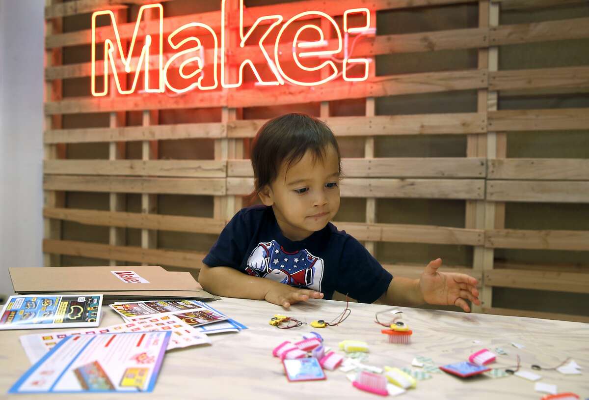Johnny Haluck, 2, plays with a Brushbot which he helped assemble at the Make magazine holiday pop-up store near Union Square in San Francisco, Calif. on Friday, Nov. 20, 2015.