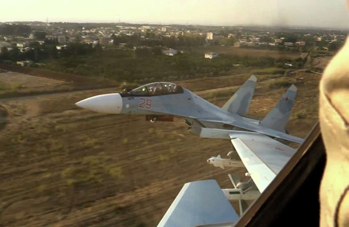 In this photo made from video made available by Russian Defense Ministry official website on Friday, Nov. 20, 2015, Russian air force Su-30 fighter jets take off from the Hemeimeem air base in Syria as part of a Russian air campaign against target in Syria, according to information provided by Russian Defense Ministry. Russian long-range bombers and navy ships have launched 101 cruise missiles in four days, including 18 fired by Russian navy ships from the Caspian Sea on Friday, according to information released by Russian Defense Ministry.