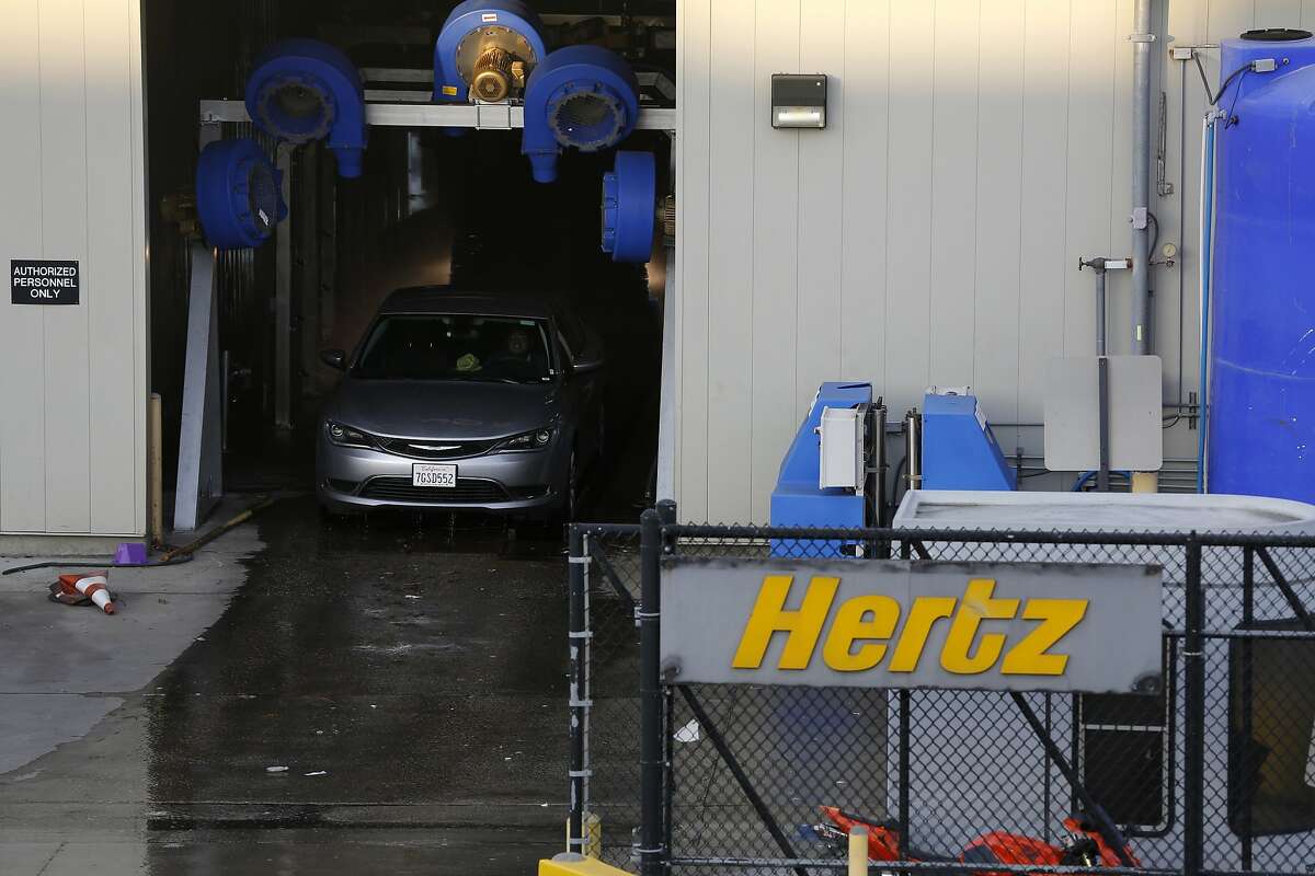 A Hertz rental car goes through a car wash at San Francisco International Airport.