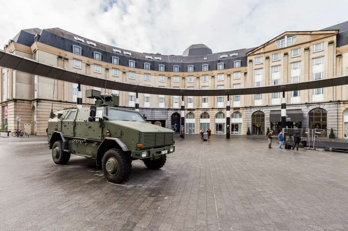 A Belgian Army vehicle is parked on the almost deserted square in front of the main train station in the center of Brussels on Sunday, Nov. 22, 2015. Western leaders stepped up the rhetoric against the Islamic State group on Sunday as residents of the Belgian capital awoke to largely empty streets and the city entered its second day under the highest threat level. With a menace of Paris-style attacks against Brussels and a missing suspect in the deadly Nov. 13 attacks in France last spotted crossing into Belgium, the city kept subways and underground trams closed for a second day. (AP Photo/Geert Vanden Wijngaert) ORG XMIT: GVW111