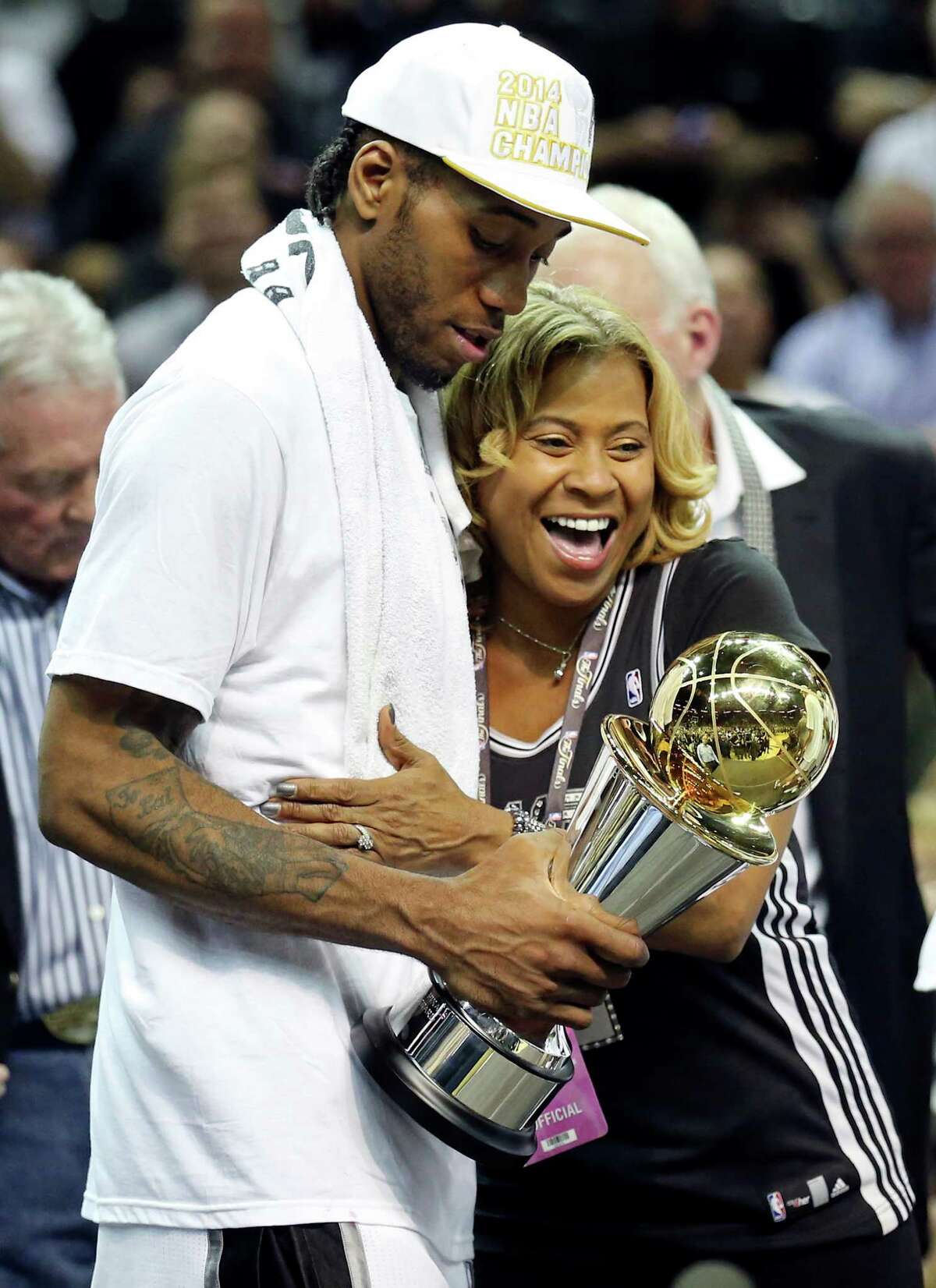 FILE - San Antonio Spurs’ Kawhi Leonard hugs his mother Kim Robertson after Game 5 of the 2014 NBA Finals against the Miami Heat on June 15, 2014 at the AT&T Center. Robertson could be seen in a Twitter video defending her son during the Spurs-Raptors game.