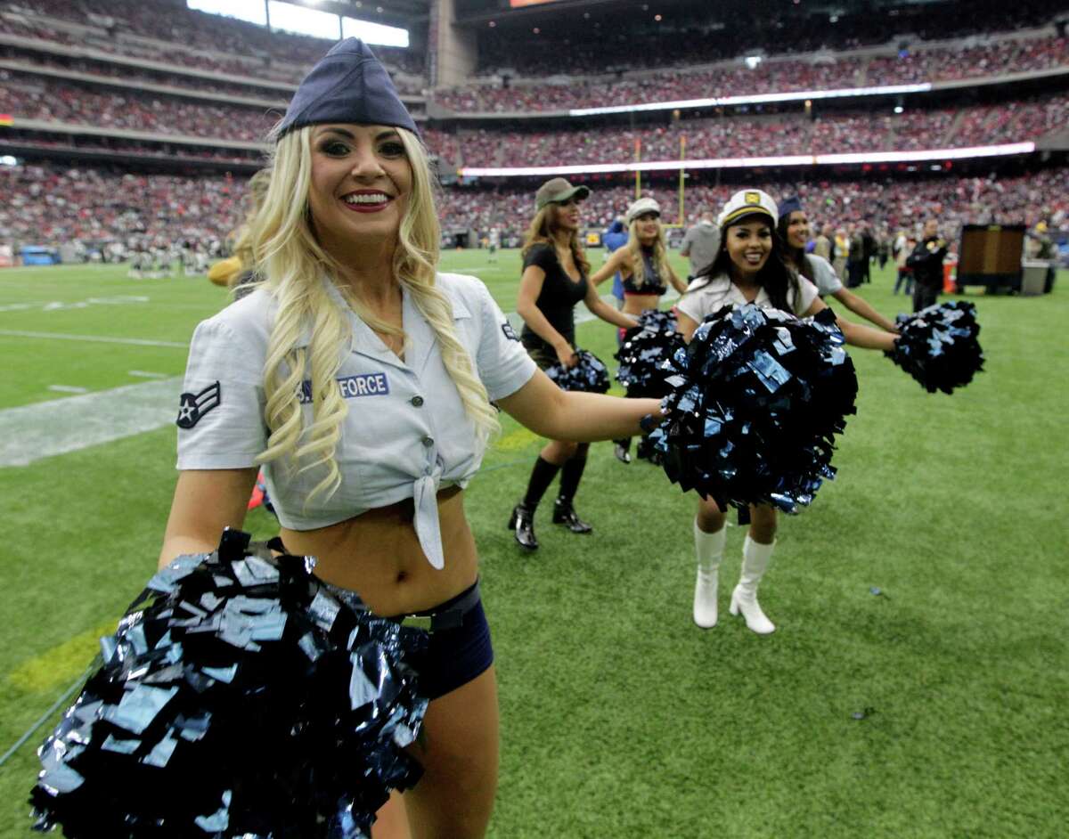 The Houston Texans cheerleaders wear military uniforms as a Salute to Service as they perform during the first half of an NFL football game, Sunday, Nov. 22, 2015, in Houston. (AP Photo/Patric Schneider)