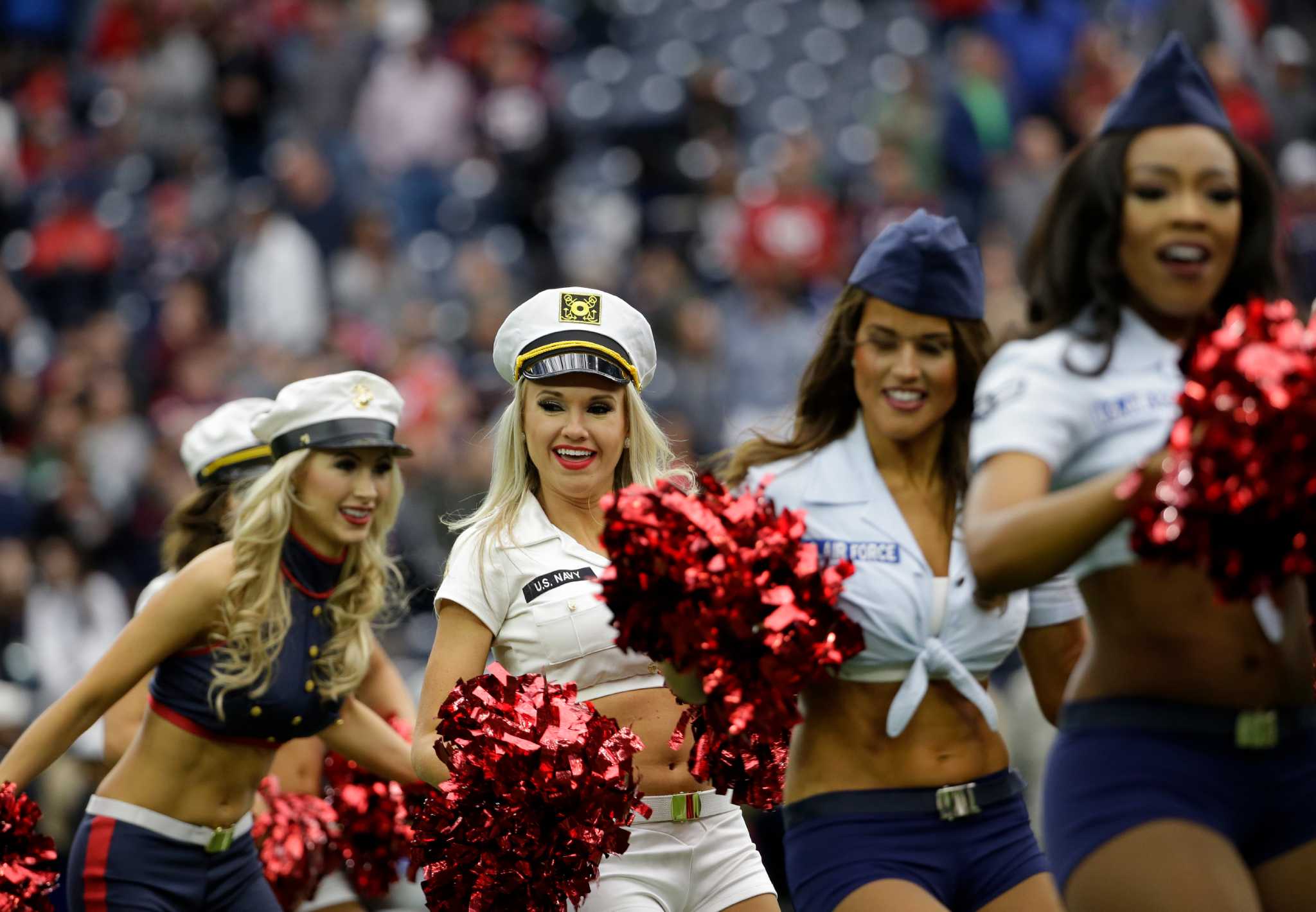 A Houston Texans cheerleader wearing a salute to service uniform