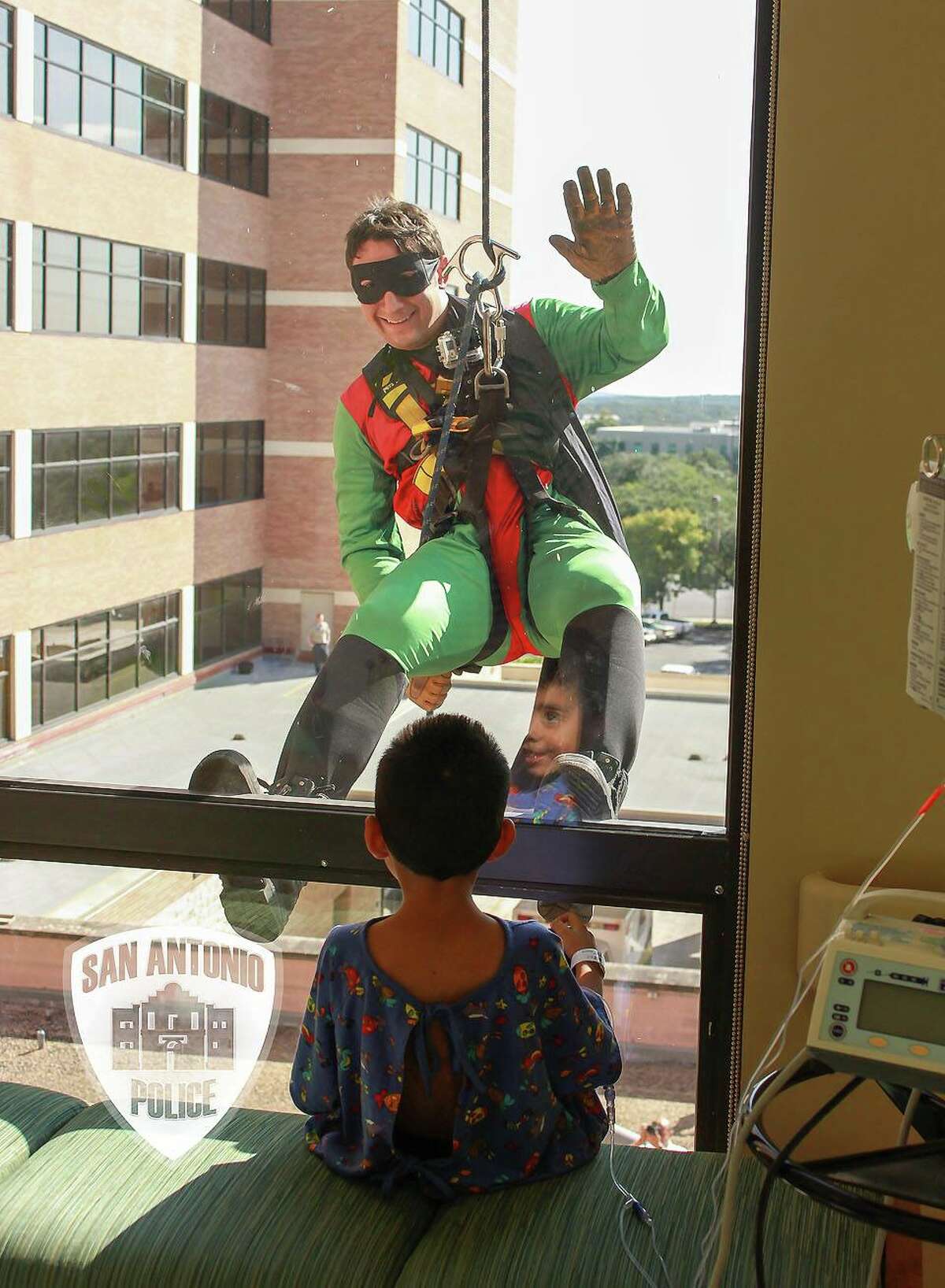San Antonio police and firefighters visited pediatric patients at North Central Baptist Hospital Friday as popular superheros.