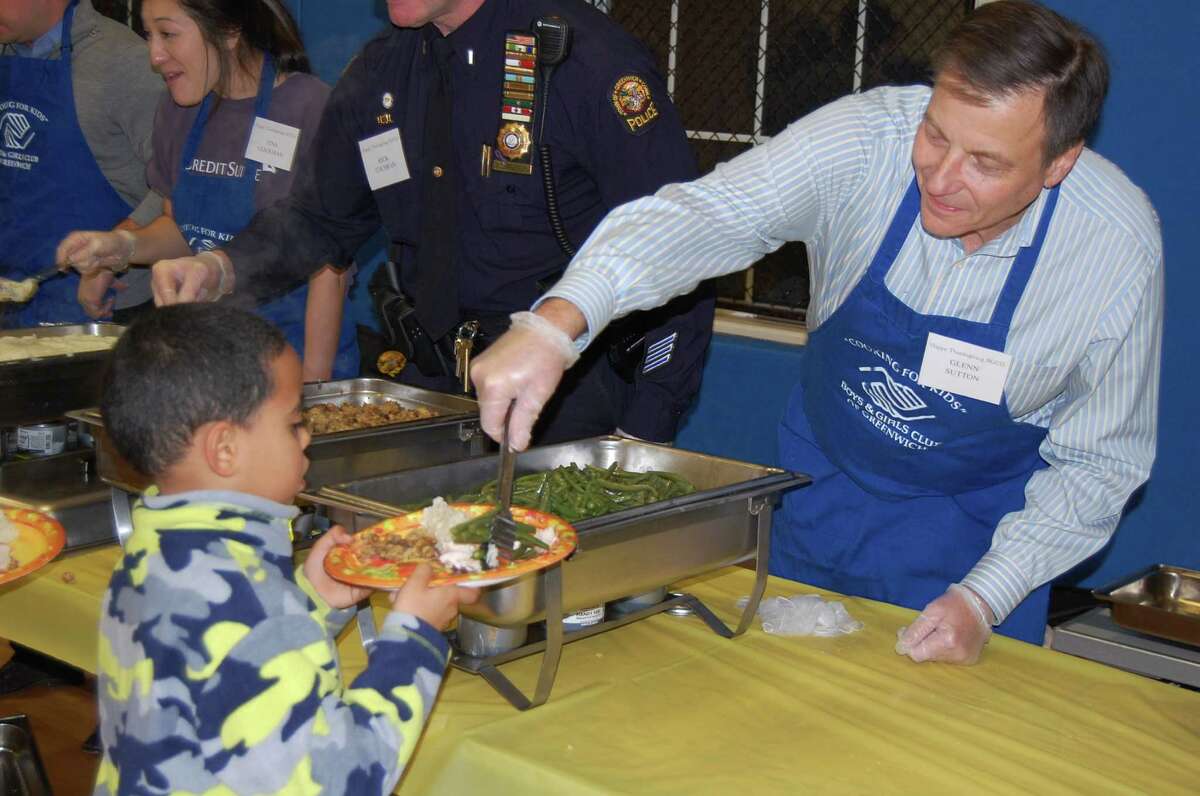 Volunteer Glenn Sutton helps serve up dinner at last year’s Boys and Girls Club of Greenwich’s annual Thanksgiving dinner. This year’s event will take place Nov. 24.