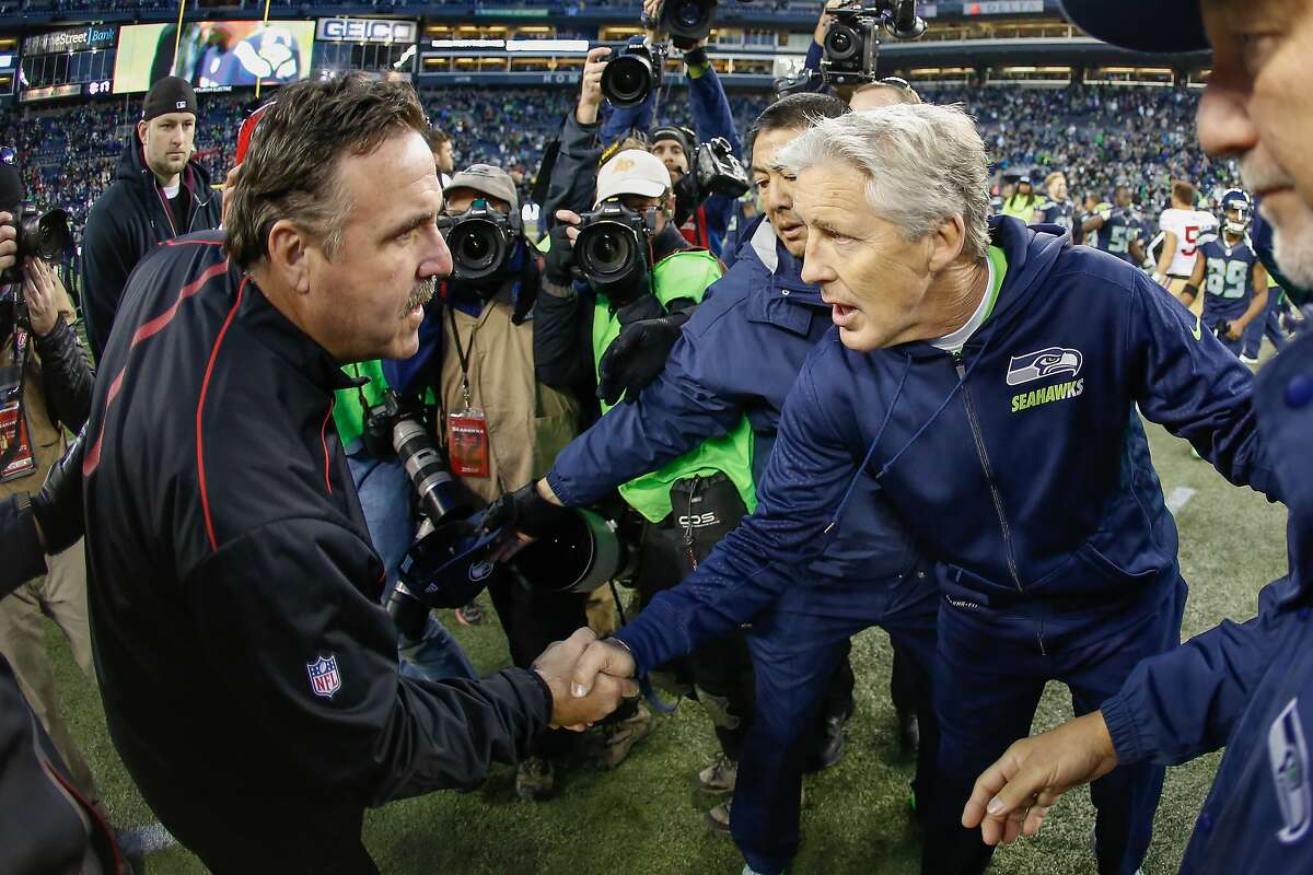 Head coach Pete Carroll (R) of the Seattle Seahawks is congratulated by Head Coach Jim Tomsula of the San Francisco 49ers after the Seahawks defeated the 49ers 29-13 at CenturyLink Field on Nov. 22, 2015 in Seattle, Washington.