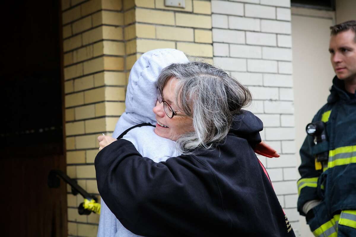 Barbara Ballesteres (left), gets a hug from her neighbor after a two-alarm fire broke out at her apartment complex at 2449 Dwight Way in Berkeley on Sunday evening, in Berkeley, California on Monday, November 23, 2015. She says of the fire, "I'm just glad everybody got out alright."