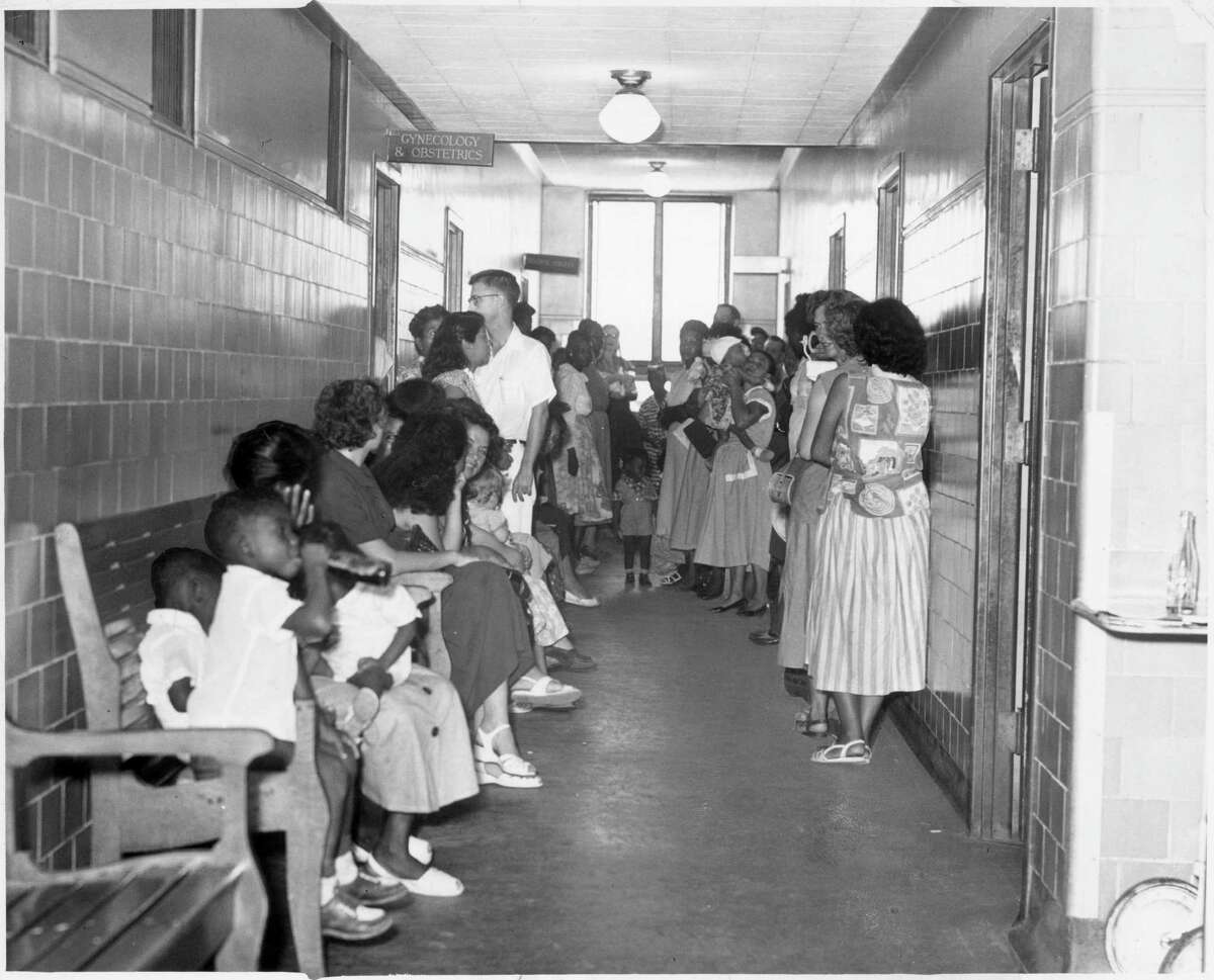 Crowded conditions at Jefferson Davis Hospital clinic waiting room, July 10, 1953.