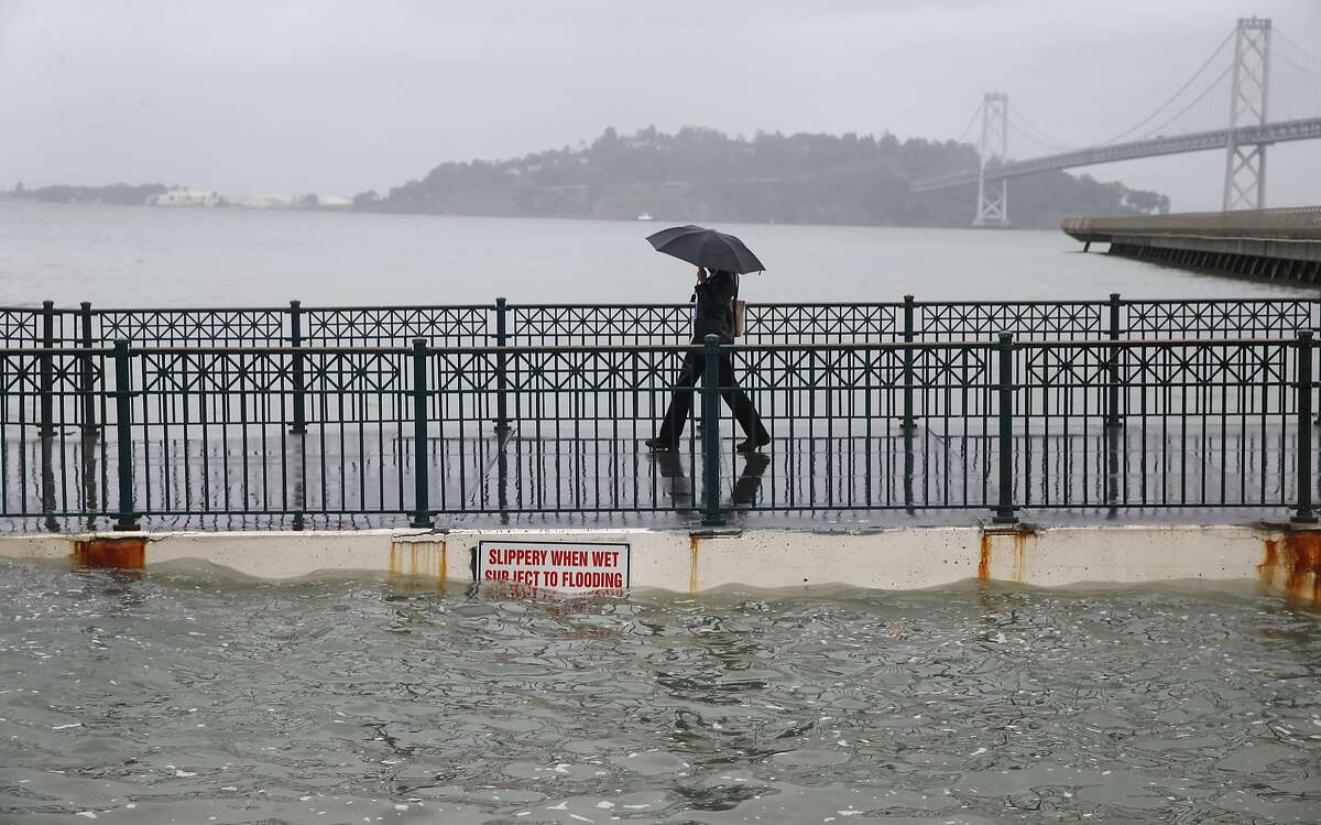 Luna Taylor walks off of Pier 14 during the peak of the high tide along the Embarcadero in San Francisco, Calif. on Tuesday, Nov. 24, 2015. Projections suggest that sea level rise could make such tides commonplace — which is part of the reason for Bay Area: Resilient by Design, a design competition where 10 multi-disciplinary teams will be awarded $250,000 each to explore how sea level rise can be managed in the decades ahead. The competition was announced this week and will run 15 months.