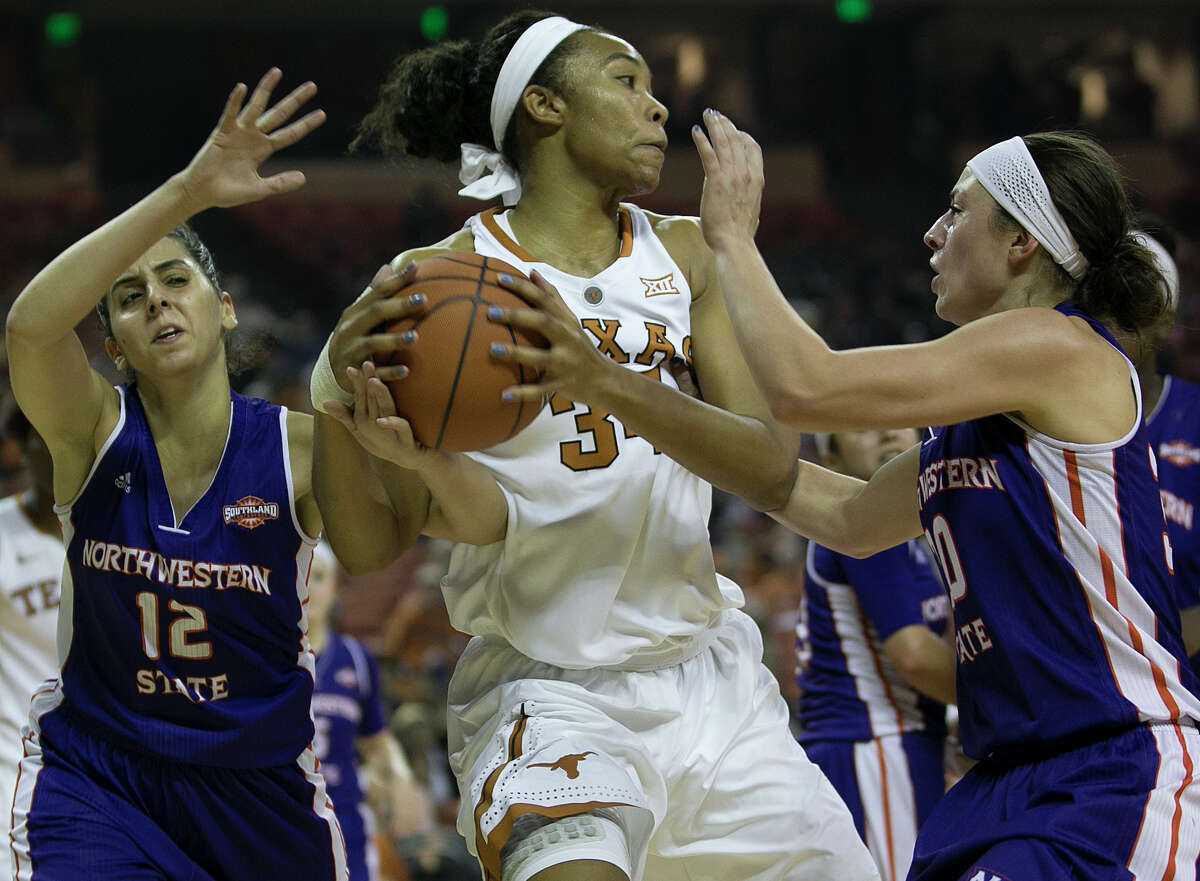 Texas’ Imani Boyette rebounds between Northwestern State’s Shahd Abbound (left) and Beatrice Attura during the first half at the Erwin Center in Austinon Nov. 18, 2015.