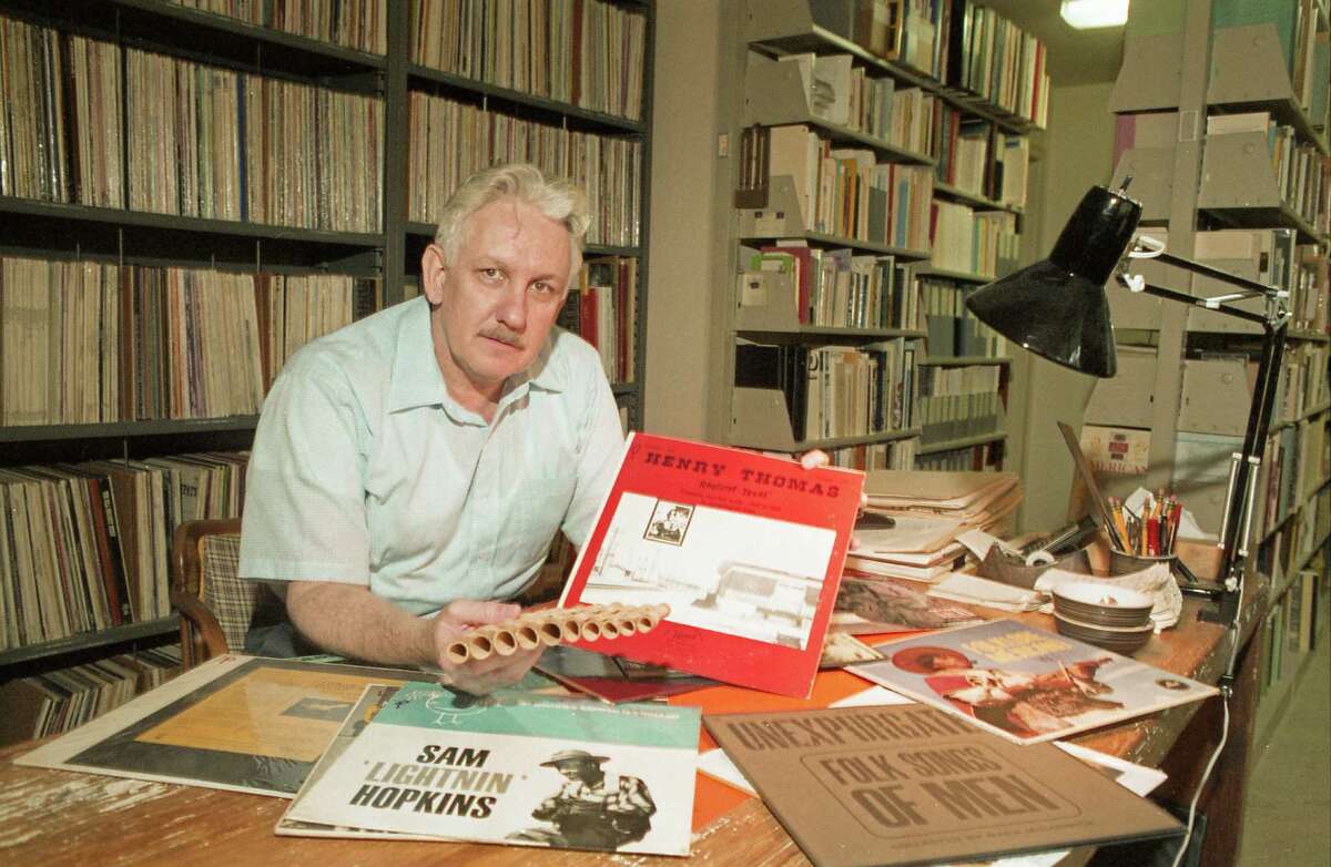 10/07/1986 - folklorist and jazz historian Robert "Mack" McCormick with some jazz album covers and a homemade cane fife