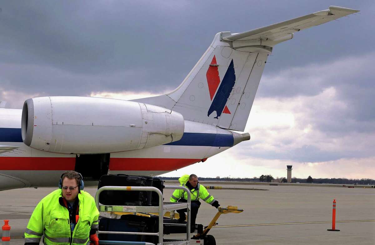 In this file photo, baggage handlers unload a jet. TSA has resisted calls to require all airport employees pass through security checkpoints, saying it’s more costly than alternative ways to monitor employees and inefficient because some employees are frequently going in and out of secure areas.