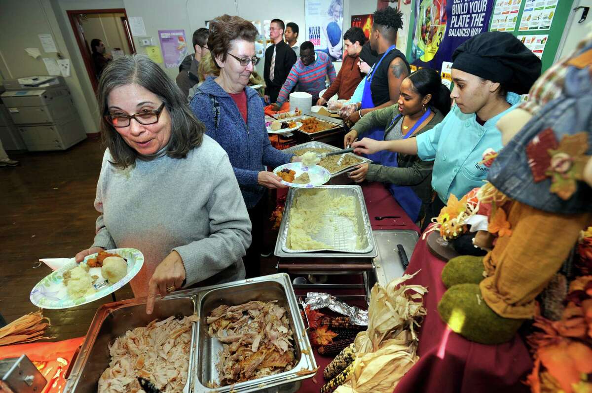 Students at the Alternative Center for Excellence along with Abbott Technical High School host an annual Thanksgiving dinner for the community at the Alternative Center Tuesday, Nov. 24, 2015.