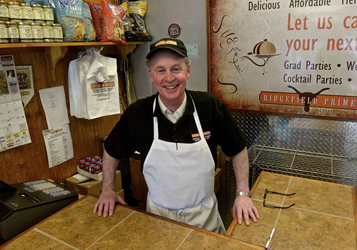 Rene Bushey orders the fish at Ridgefield Prime, a butcher shop and fish store in Ridgefield, that sells only farm-raised and organic salmon. The FDA says genetically modified salmon does not need to be labeled as such before selling.