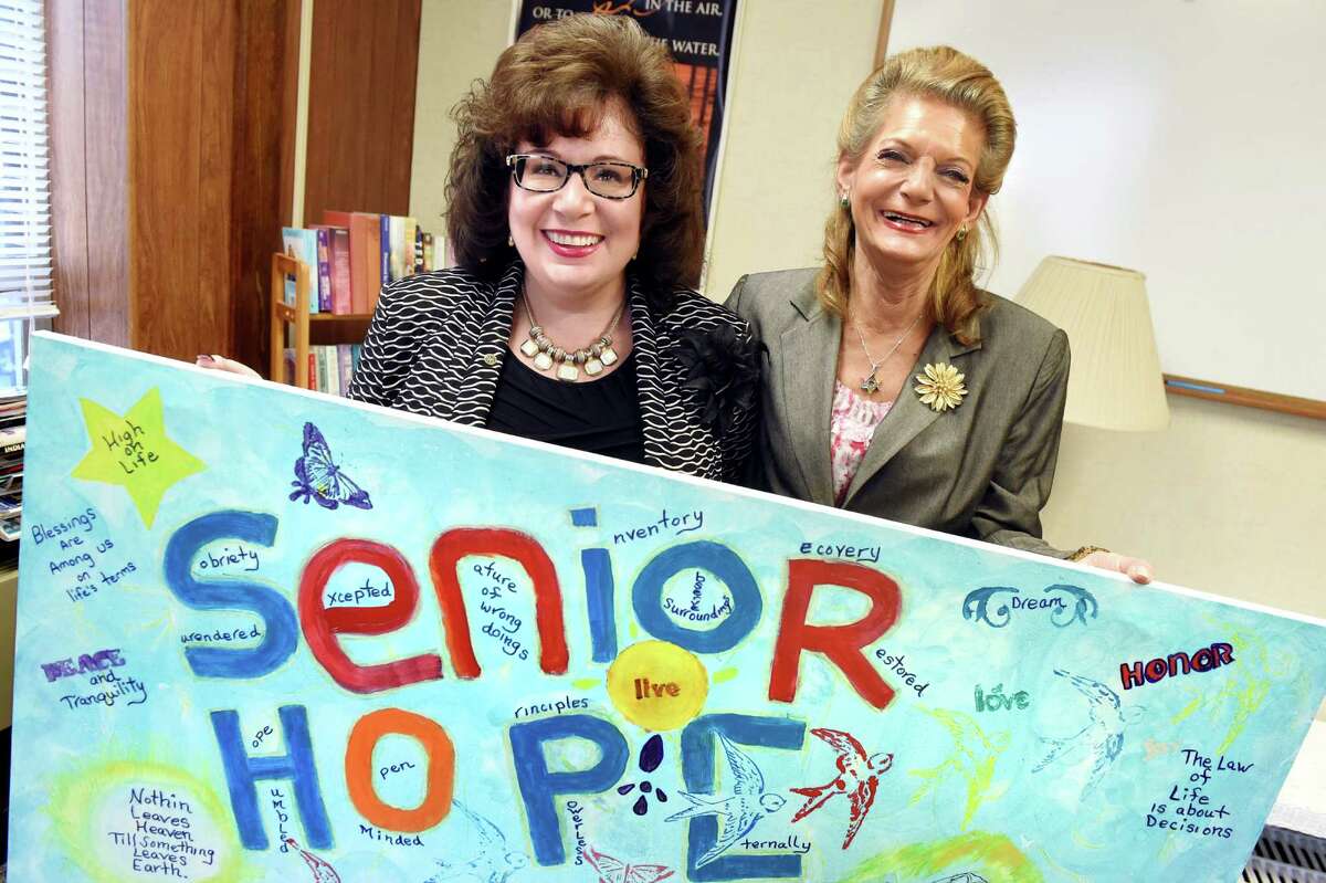 Executive director Nicole McFarland, left, and successful program graduate Sherri Finkel hold artwork honoring Senior Hope on Tuesday, Nov. 24, 2015, at Senior Hope in Albany, N.Y. (Cindy Schultz / Times Union)