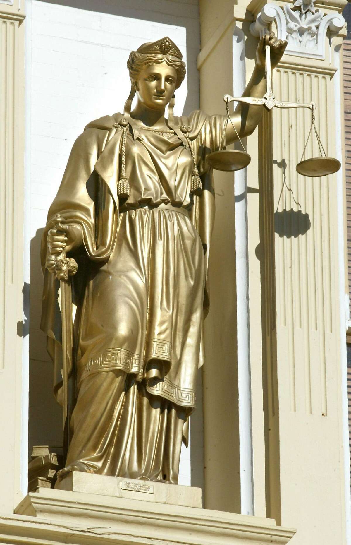 TRAVEL ** FILE **Justice is not blind in Virginia City, Nev. Bucking convention, the statue of Lady Liberty, who holds the Scales of Justice on the 1876 Washoe County Court House, wears no blindfold, seen in this June 2003 file photo. Virginia City stands today as the largest historic district in the United States. Much of the town is preserved and restored to the way it was when it was rebuilt from a consuming fire in 1875. (AP Photo/Orange County Register, Jebb Harris)