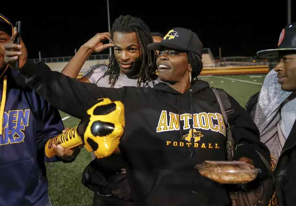 [Image: Najee Harris whipping his dreadlocks back during high school practice at Antioch High]
