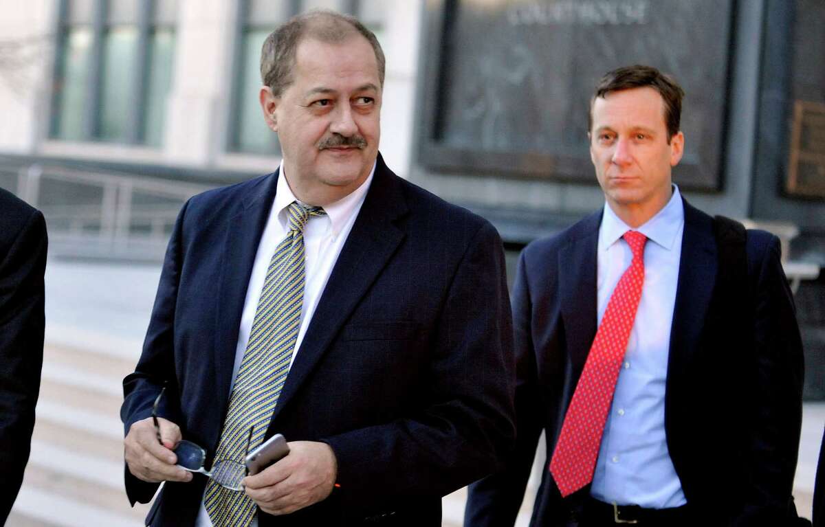 Former Massey Energy CEO Don Blankenship walks out of the Robert C. Byrd U.S. Courthouse after the jury deliberated for a fifth full day in his trial Tuesday, Nov. 24, 2015, in Charleston, W.Va. Blankenship is charged with conspiring to break safety laws and defrauding mine regulators at West Virginia's Upper Big Branch Mine, and lying to financial regulators and investors about safety. The mine exploded in 2010, killing 29 men. (AP Photo/Chris Tilley)