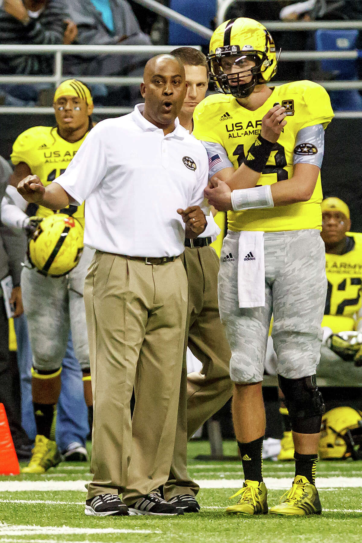 Steele’s Mike Jinks (left), head coach of the West Team in the 13th U.S. Army All-American Bowl at the Alamodome on Jan. 5, 2013, speaks with starting quarterback Max Browne during the second half.