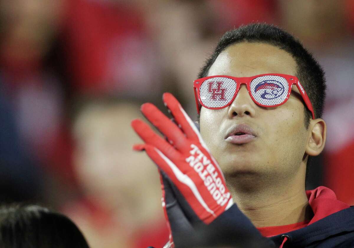 Alejandro Dolores, a 19-year-old sophomore studying finance, yells from the stands before the start of an AAC football game at TDECU Stadium Saturday, Nov. 14, 2015, in Houston. "I bleed red, I love UH," he said.