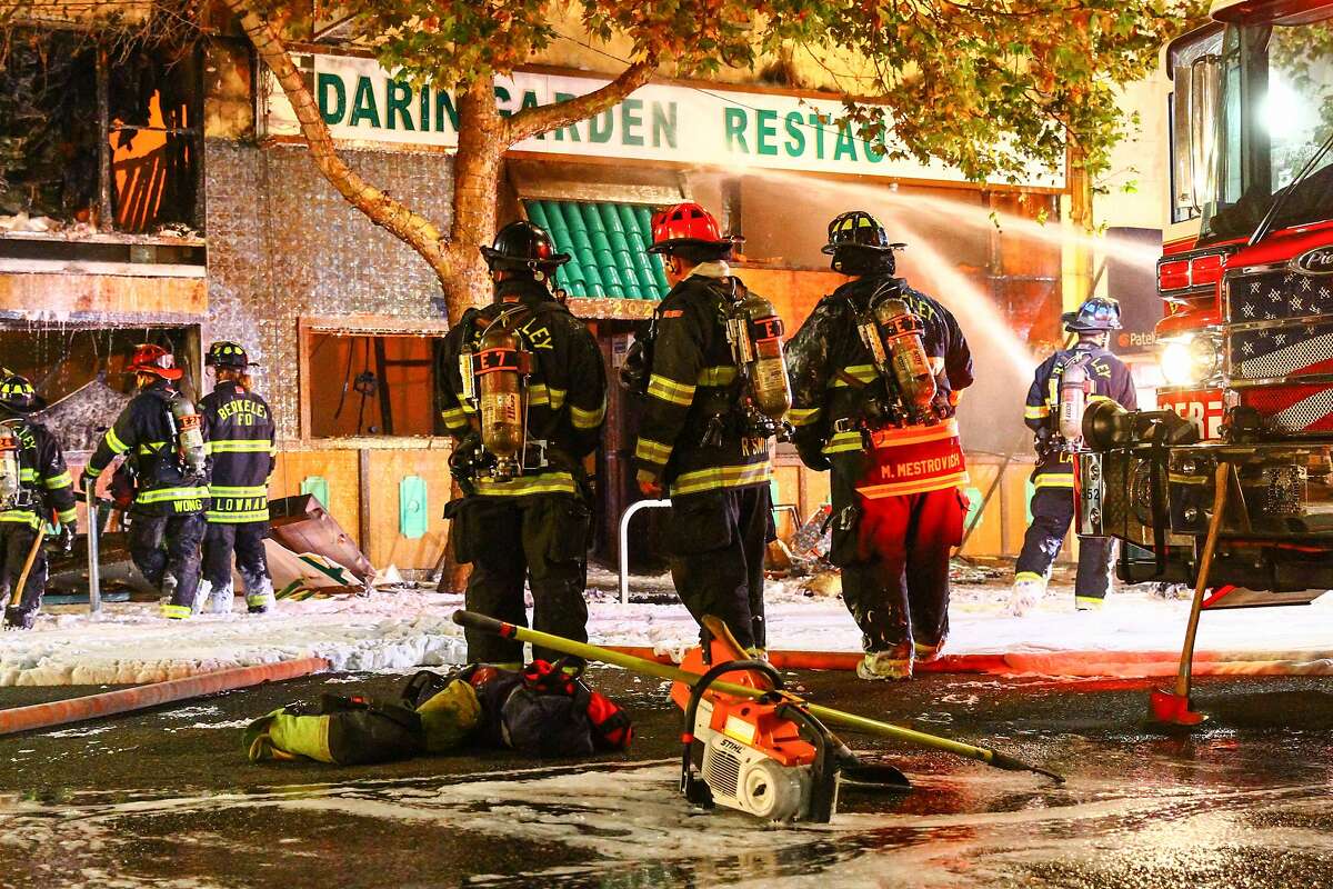 Berkeley firefighters extinguish the remaining embers of a fire at the Mandarin Garden Restaurant on Shattuck Ave. in Berkeley, Calif on Friday, November 27, 2015.