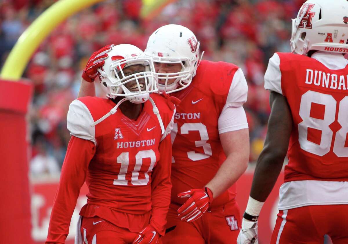 Houston Cougars wide receiver Demarcus Ayers (10) is congratulated by Houston Cougars offensive lineman Colton Freeman (73) after scoring on a 62-yard touchdown pass from Houston Cougars quarterback Greg Ward Jr. (1) against the Navy Midshipmen in the third quarter in a NCAA college football game at TDECU Stadium Friday, Nov. 27, 2015, in Houston, Texas. Houston won 52-31 clinching the AAC West Division Title.