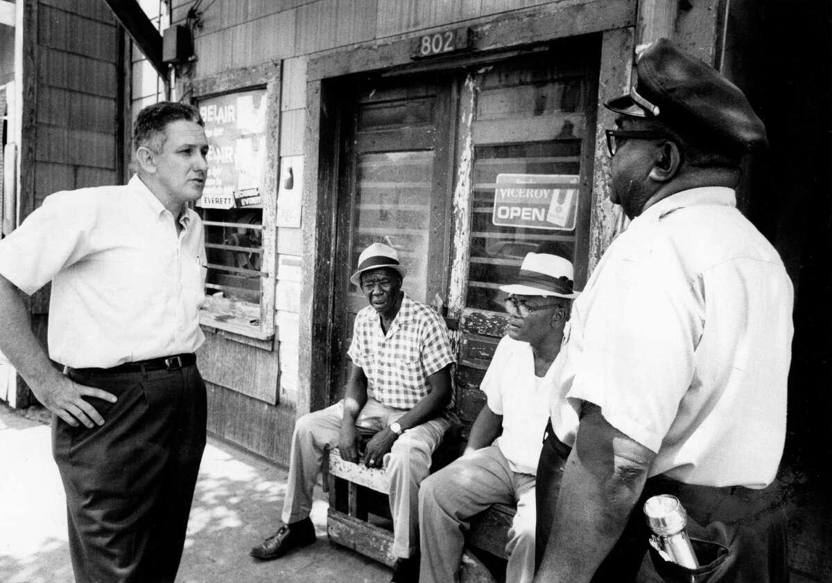 Folklorist and historian Robert "Mack" McCormick speaks to Fourth Ward residents while in search of Snowball Horton﻿. McCormick was a crucial documentarian of African-American music forms.