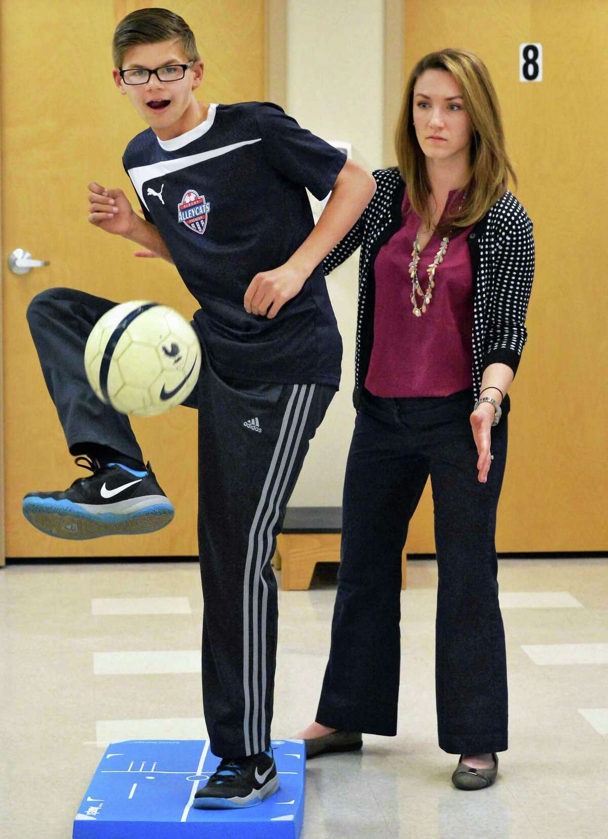 Physical therapist Audrey Paslow, right, conducts a sports readiness exercise with Conor Van Sise, 14, of the Albany Alleycats soccer club, at Ellis Medicine Friday Nov.20, 2015 in Clifton Park, NY. (John Carl D'Annibale / Times Union)
