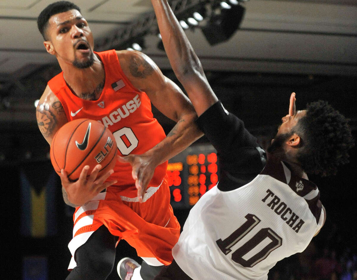 Syracuse’s Michael Gbinije drives to the basket against Texas A&M’s Tonny Trocha-Morelos in the championship game of the Battle 4 Atlantis at Imperial Arena in Nassau, Bahamas, on Nov. 27, 2015. Syracuse won, 74-67, and Gbinije was named tournament MVP.