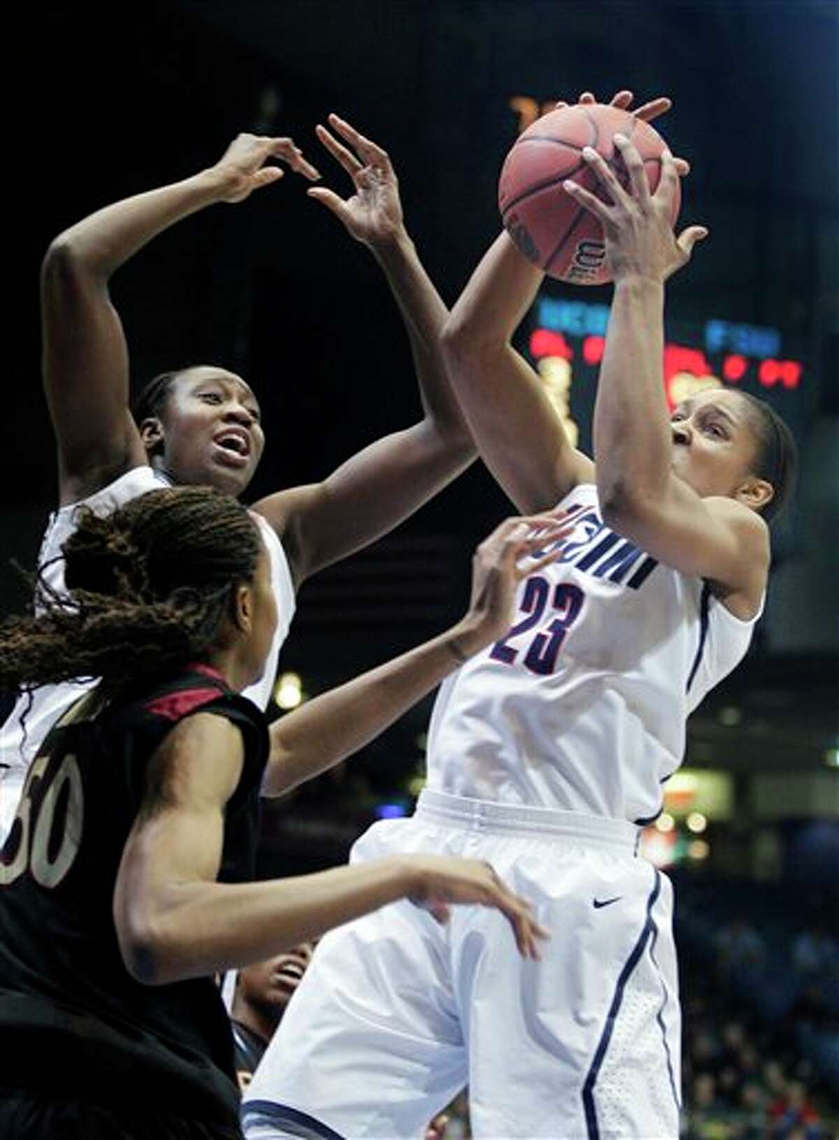 Connecticut's Maya Moore (23) grabs a rebound in front of Florida State's Chasity Clayton in the first half of the NCAA Dayton Regional final college basketball game Tuesday, March 30, 2010, in Dayton, Ohio. (AP Photo/Skip Peterson)