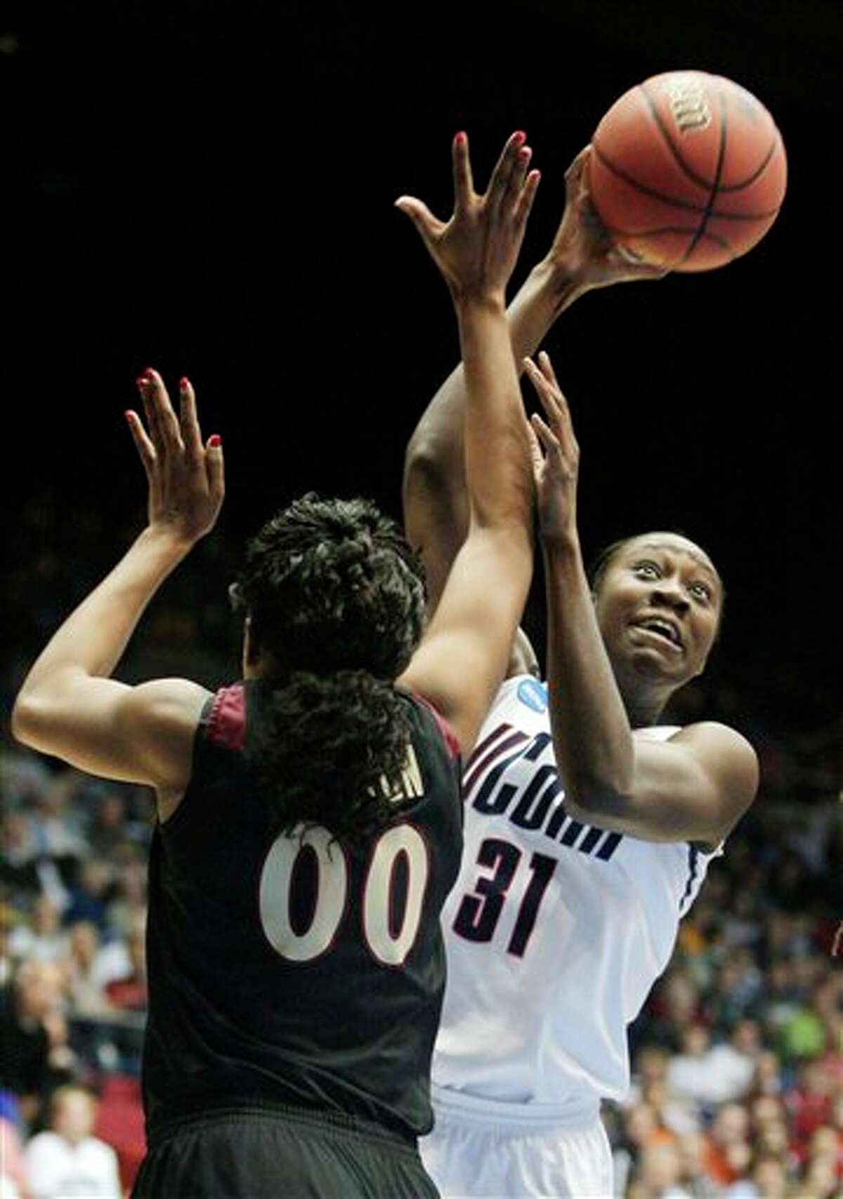 Connecticut's Tina Charles (31) shoots over Florida State's Chasity Clayton (00) in the first half of the NCAA Dayton Regional final college basketball game Tuesday, March 30, 2010, in Dayton, Ohio. (AP Photo/Skip Peterson)