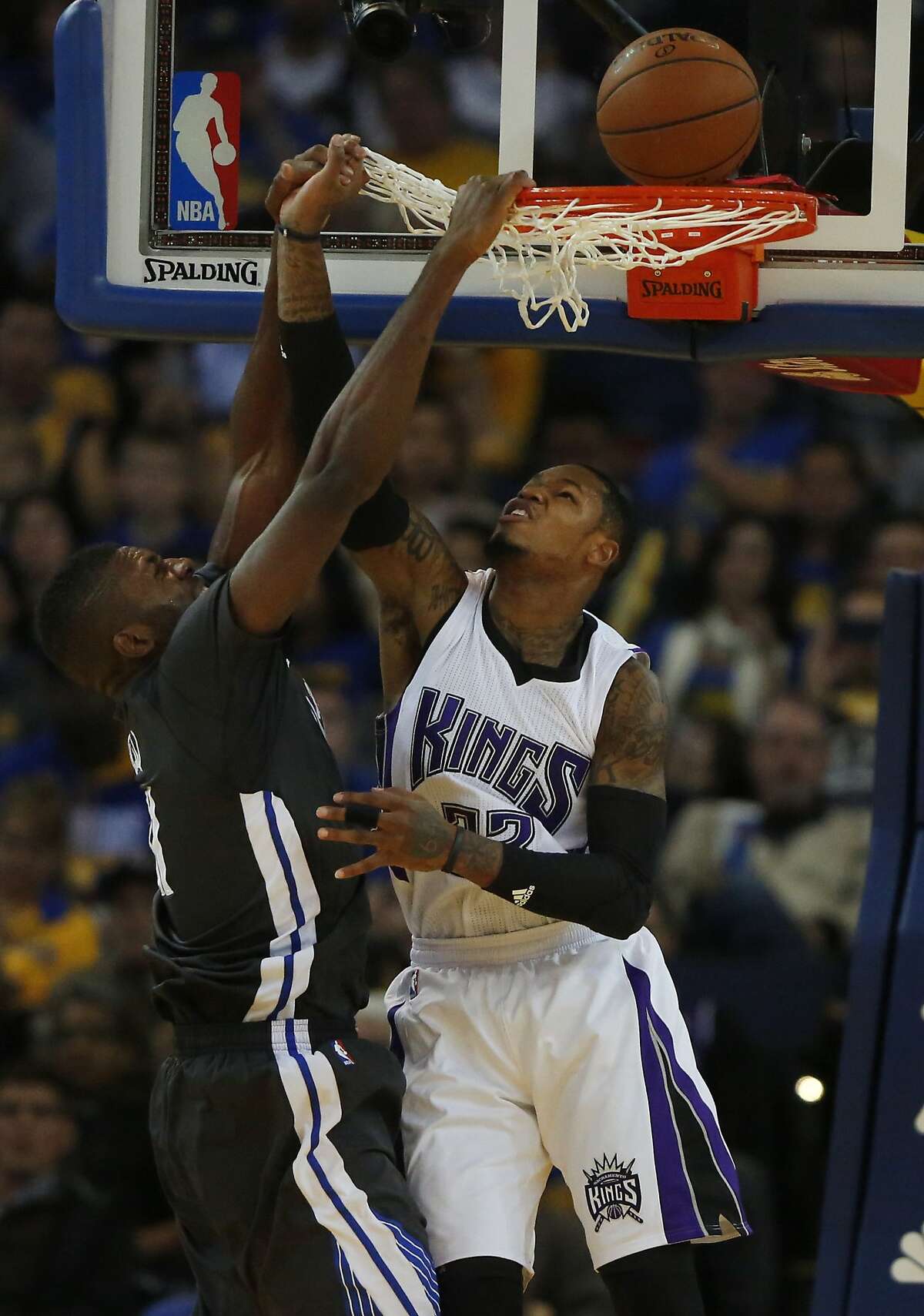 Warriors' Festus Ezeli attempts a slam dunk as the Kings' Ben McLemore attempts a block during the Golden State Warriors vs. the Sacramento Kings game in Oracle Arena Nov. 28, 2015 in Oakland, Calif.