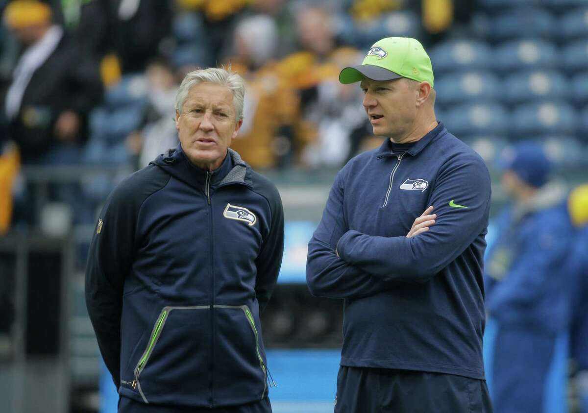 Seattle Seahawks head coach Pete Carroll, left, stands with offensive coordinator Darrell Bevell before an NFL football game against the Pittsburgh Steelers, Sunday, Nov. 29, 2015, in Seattle. (AP Photo/Ted S. Warren)