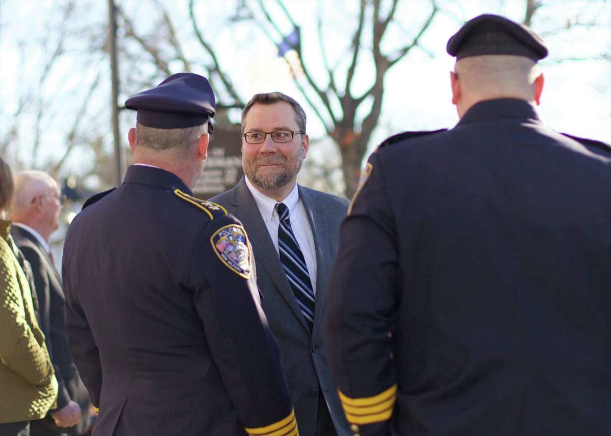 Newly elected mayor David Gronbach (and the other new commission and board members in New Milford) wait to be sworn on the front steps of New Milford Town Hall at 2 p.m. Sunday, Nov. 29, 2015. Here, David Gronbach talks with New Milford Police Chief Shawn Boyne and Officer Mark Buckley.