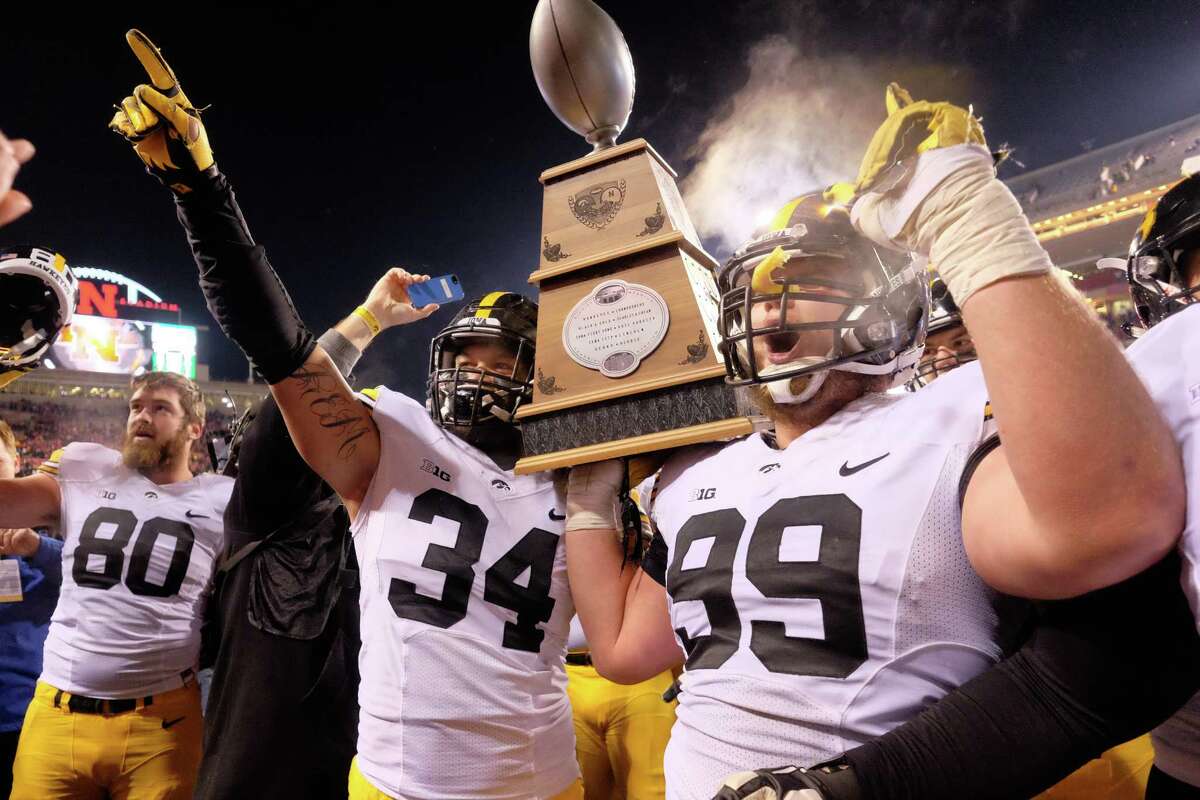 Around the nation: Iowa, the biggest surprise of the season, kept plugging along with a 28-20 victory at Nebraska. Now, the No. 4 Hawkeyes face one final hurdle: No. 5 Michigan State in the Big Ten title game. Iowa likely will welcome the doubters who don’t believe they can get by the Spartans, because pretty much the rest of the nation has doubted the Hawkeyes all season.