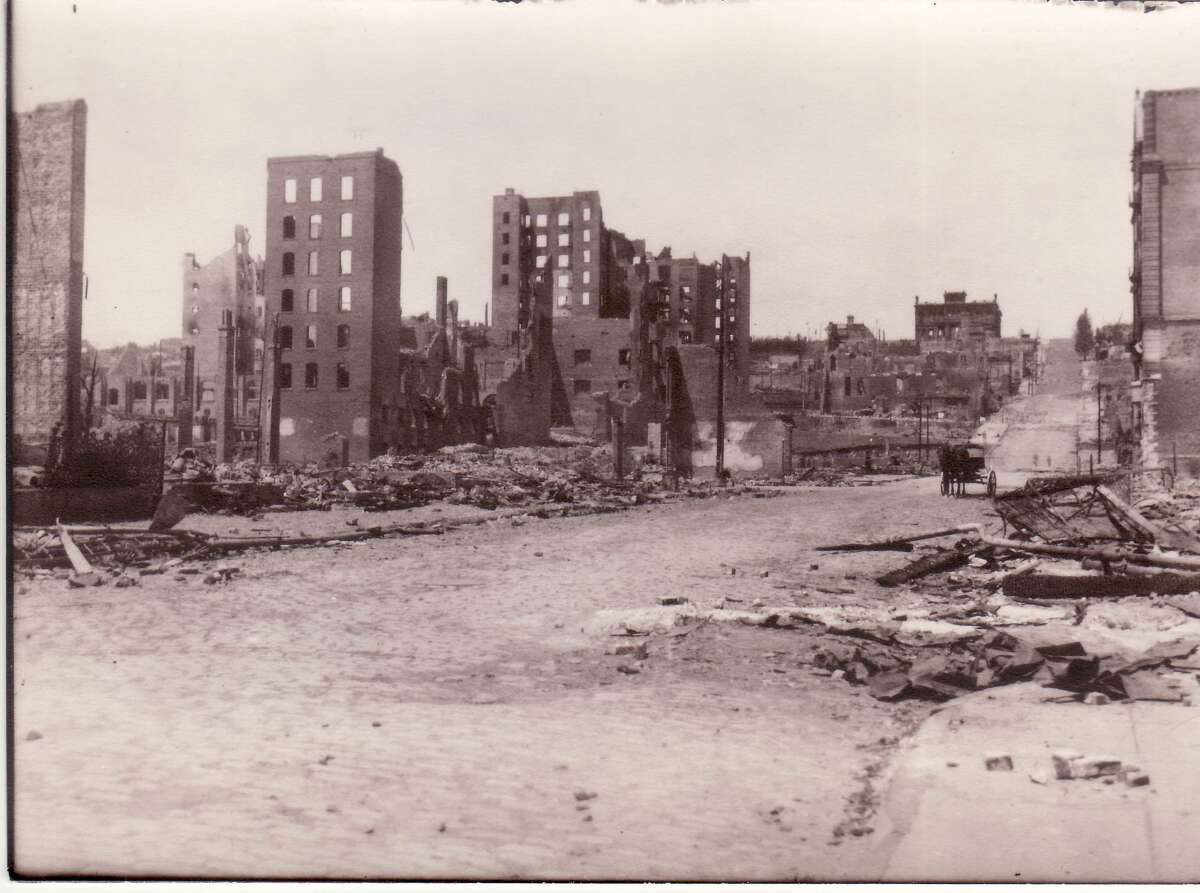 This photo was taken by John Ashley Tyson, a survivor of the 1906 San Francisco earthquake, and original owner of the book. From the original glass negative. Courtesy of Terri L. Roberts (Tyson). The exact location was unknown. This photo is looking north on Mason Street from around Geary Street.  The building on the right is the ruins of Native Sons Hall at 414 Mason Street.  In the distance, to the left of the street, is the ruins of the Flood Mansion.