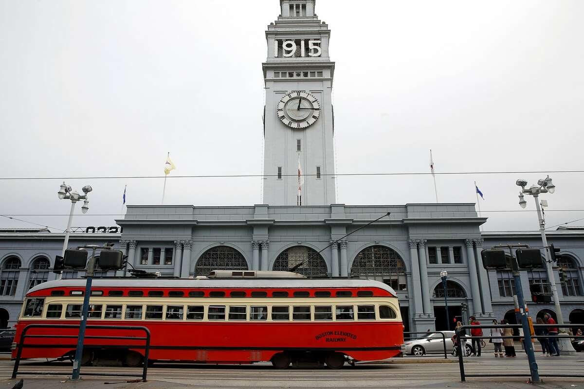 A Muni streetcar drives past the Ferry Building on The Embarcadero in San Francisco, California, on Monday, Nov. 30, 2015.