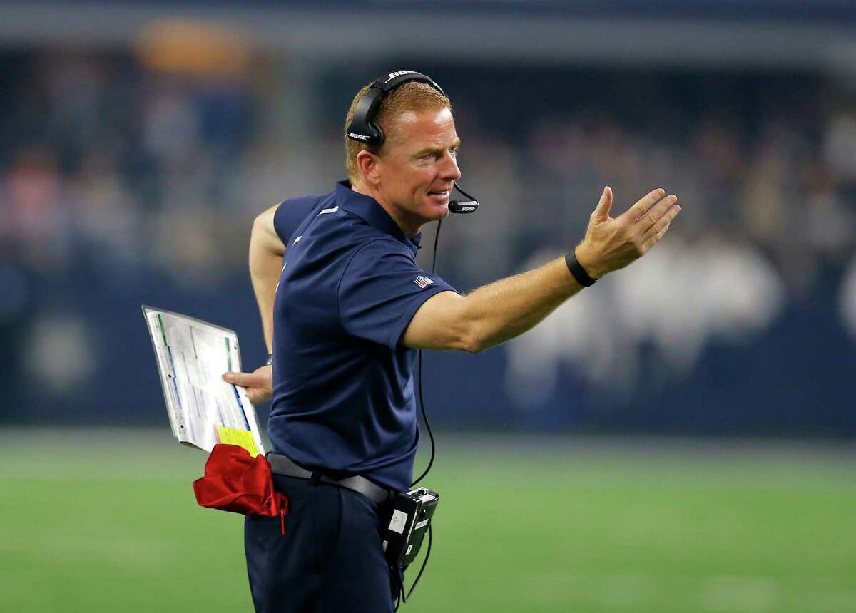 Dallas Cowboys head coach Jason Garrett talks with officials from the sideline during a challenge in the first half against the Carolina Panthers on Nov. 26, 2015, in Arlington.
